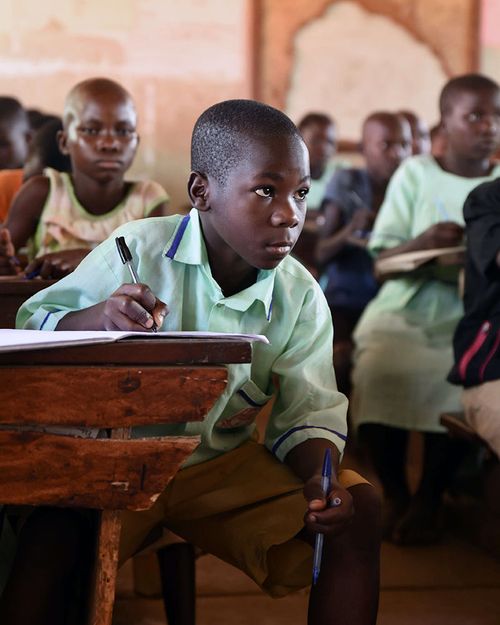 AOK Foundation team working with students on an education programme